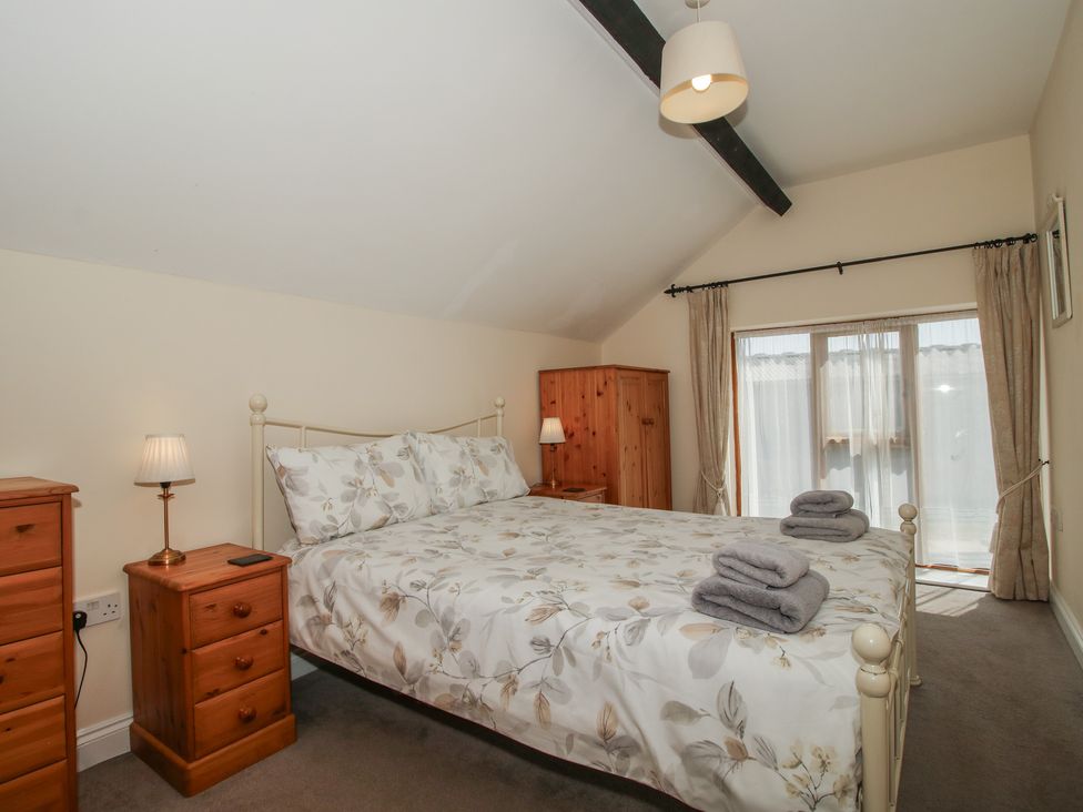 A bedroom with a bed and bedside tables at The Wainhouse in Bockleton near Tenbury Wells