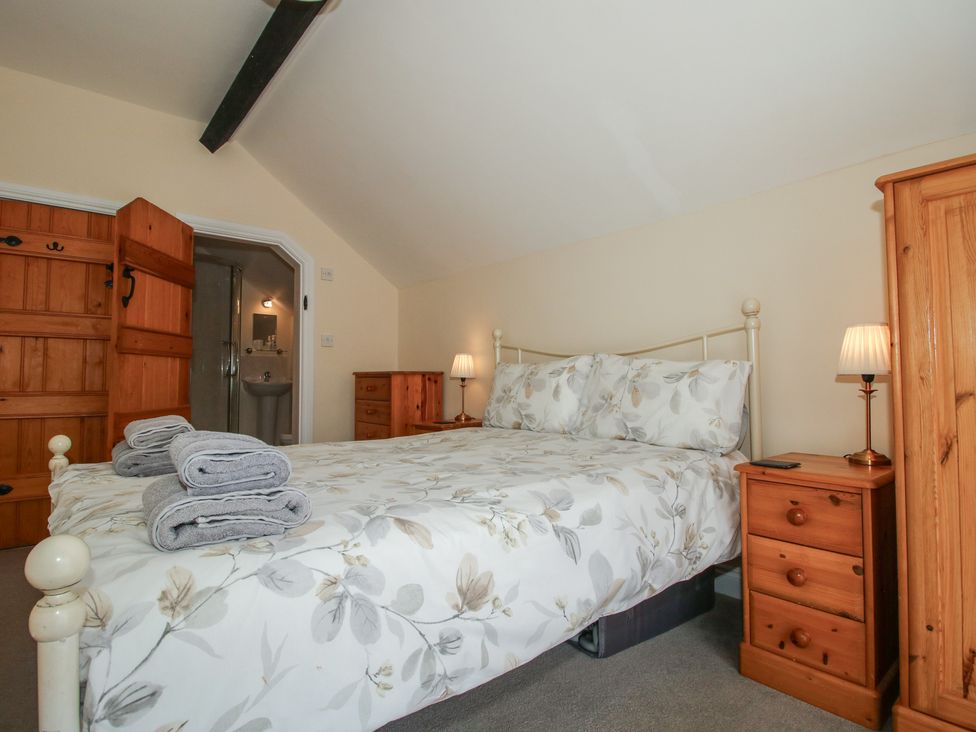 A bedroom with a bed and bedside table at The Wainhouse in Bockleton near Tenbury Wells