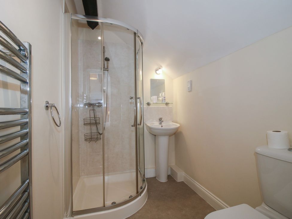A bathroom with a shower, sink, and toilet at The Wainhouse in Bockleton near Tenbury Wells