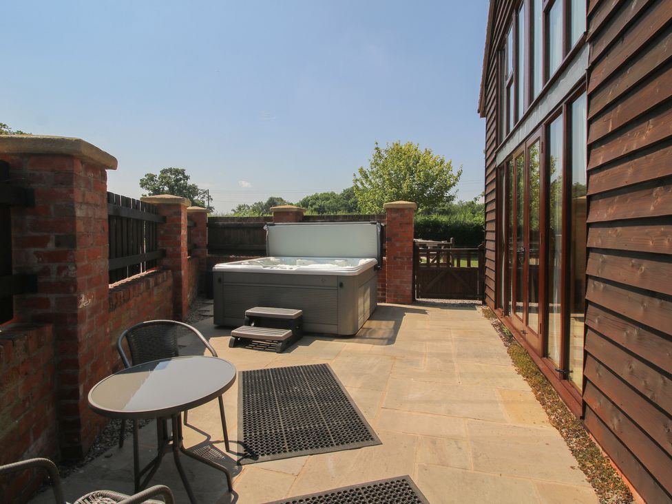 An outdoor area with a hot tub and seating at The Wainhouse Bockleton near Tenbury Wells