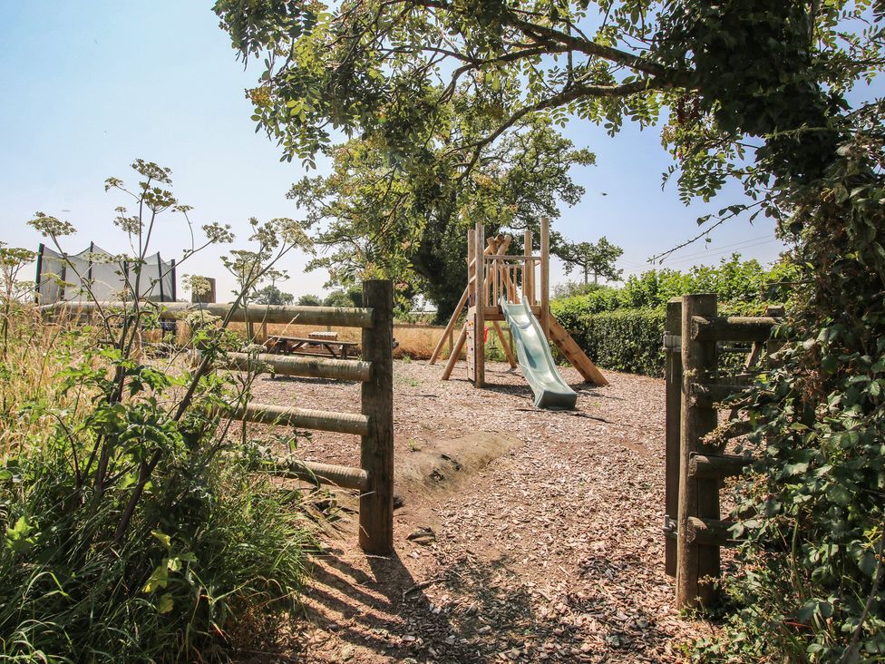 A playground with a slide and picnic table at The Wainhouse in Bockleton near Tenbury Wells