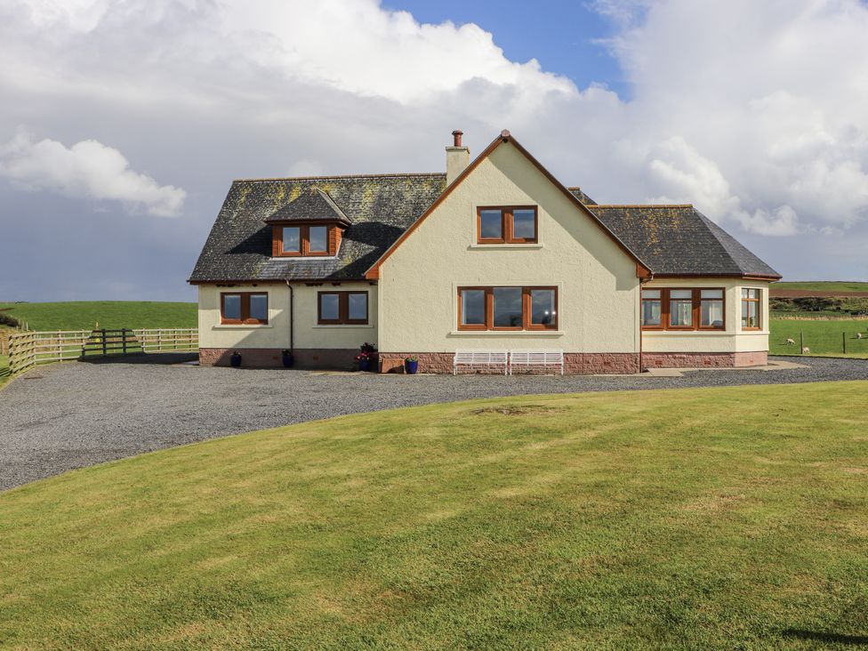 A house with windows and a driveway at Corsewall Castle Farm Lodges in Kirkcolm