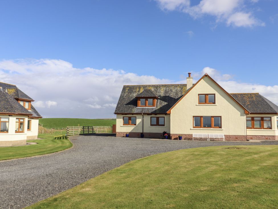 A house with a driveway and grass area at Corsewall Castle Farm Lodges Kirkcolm