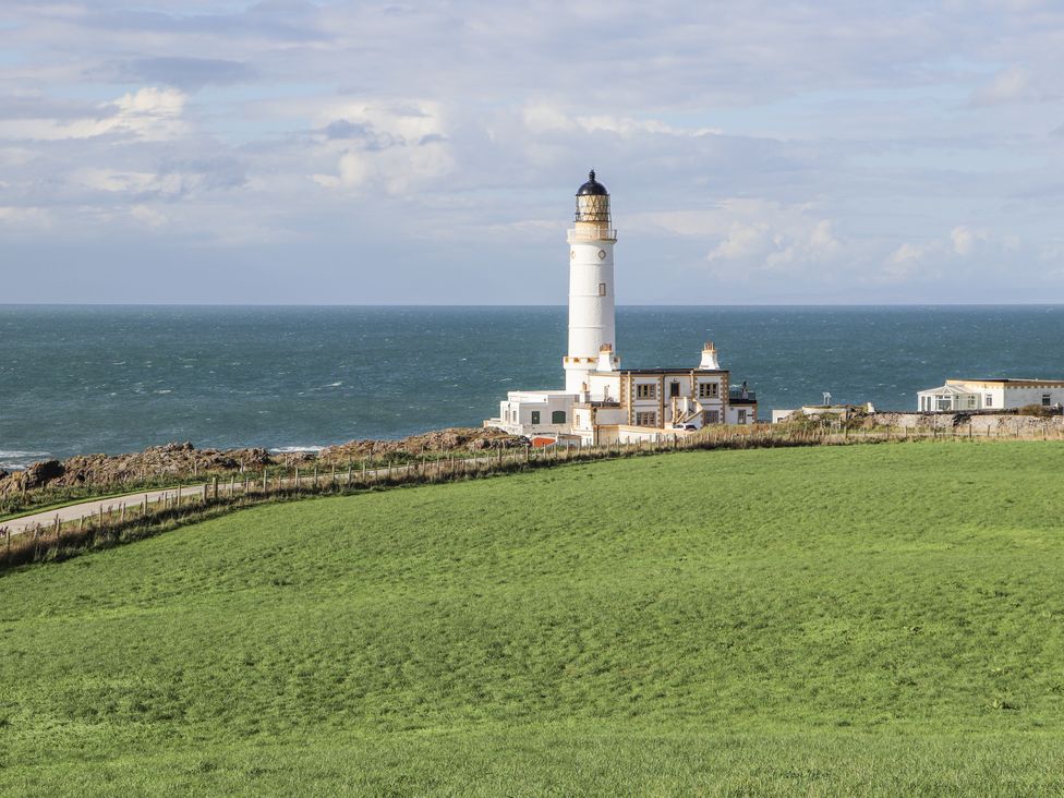 A lighthouse near the sea at Corsewall Castle Farm Lodges in Kirkcolm