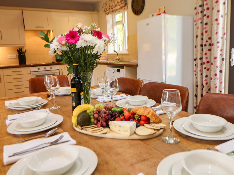 A kitchen with a dining table set for a meal at Wensley in Matlock