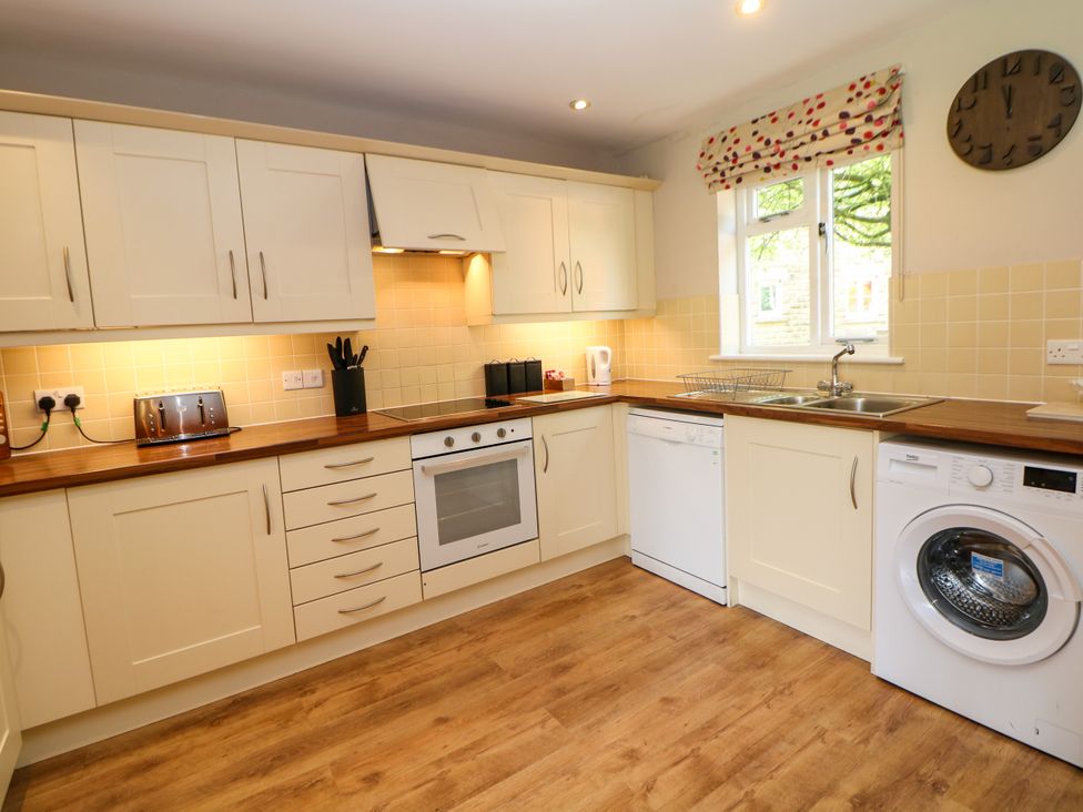 A kitchen with appliances and cabinets at Wensley in Matlock