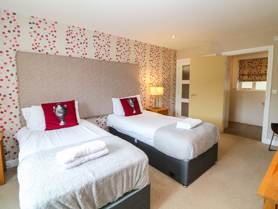 A bedroom with two beds and a window at Wensley in Matlock