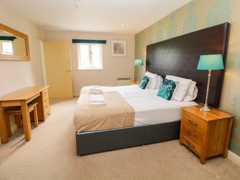 A bedroom with a bed and desk at Wensley in Matlock