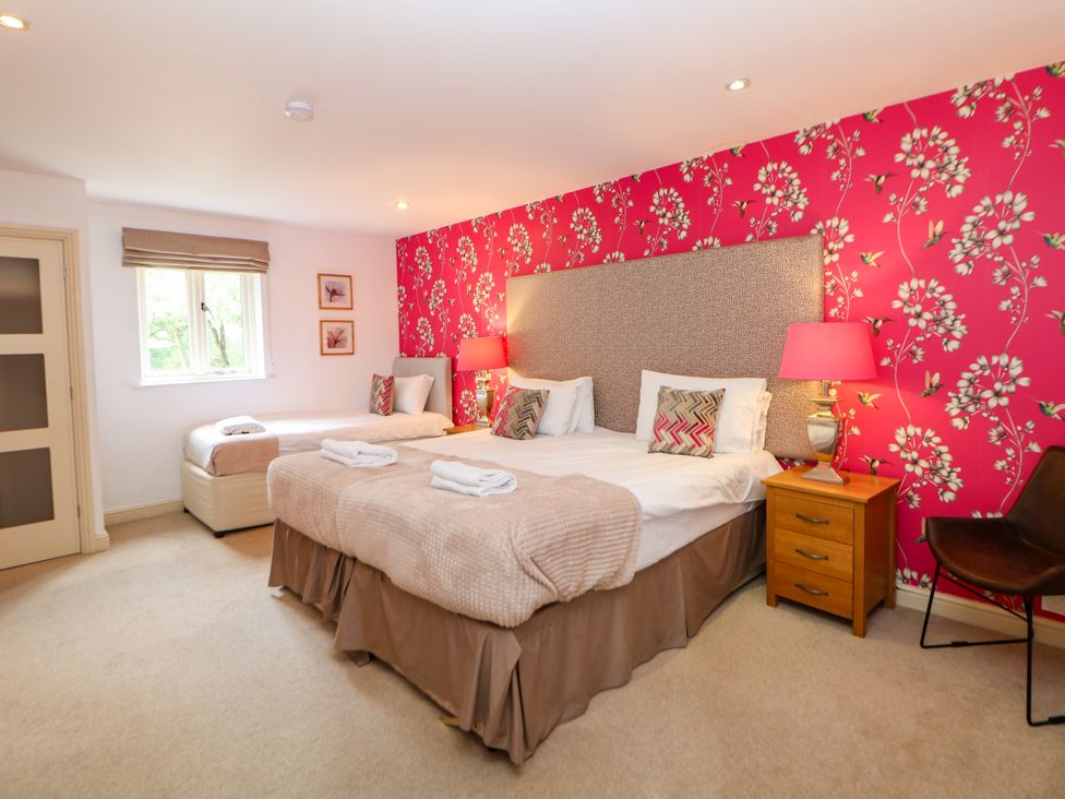 A bedroom with two beds and a window at Wensley in Matlock