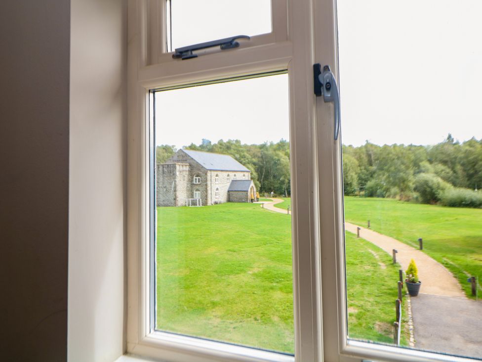 A view from a window showing a building and a garden at Wensley in Matlock
