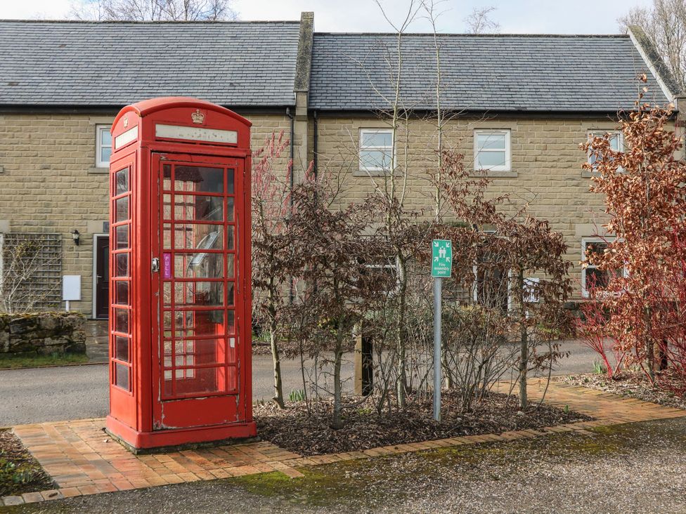A telephone box and a house in an outdoor area at Wensley Matlock