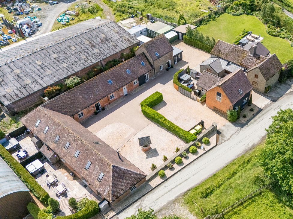 An outdoor area with multiple buildings and a gravel driveway at The Old Farmhouse in Westhope