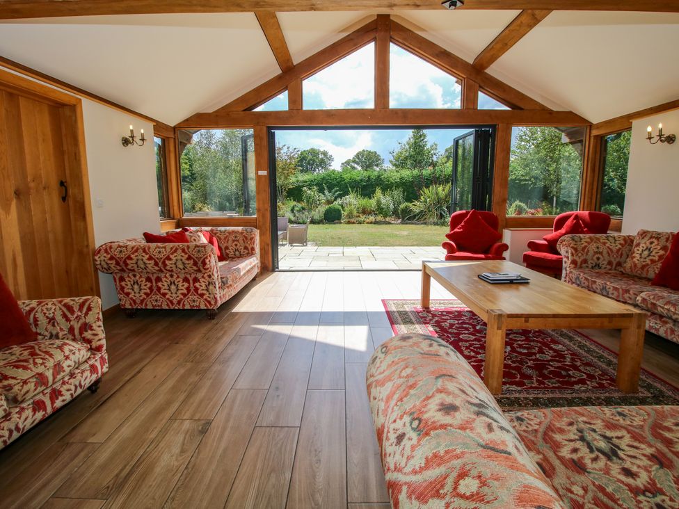 A garden room with sofas and a coffee table at The Old Farmhouse Westhope