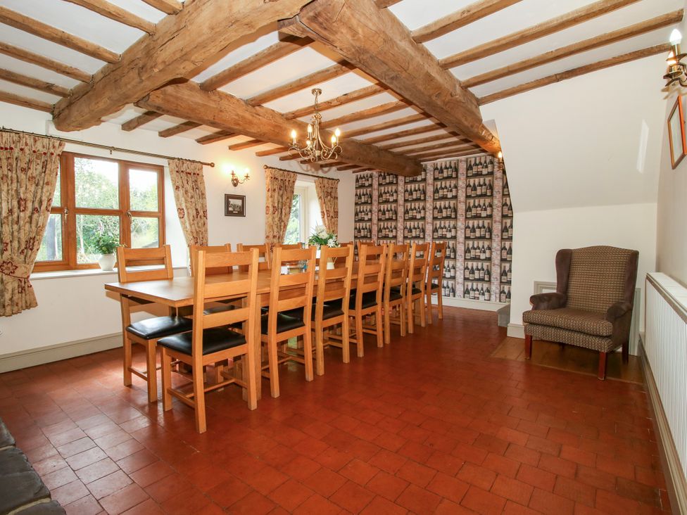 A dining room with a table and chairs at The Old Farmhouse in Westhope