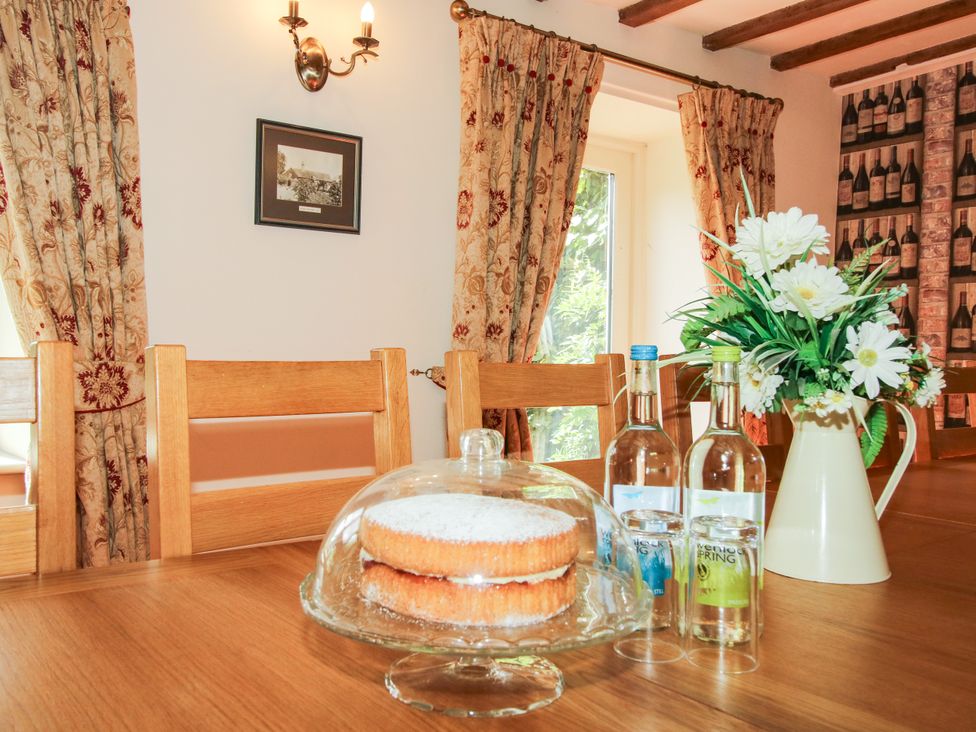 A dining room with a cake on a table at The Old Farmhouse in Westhope