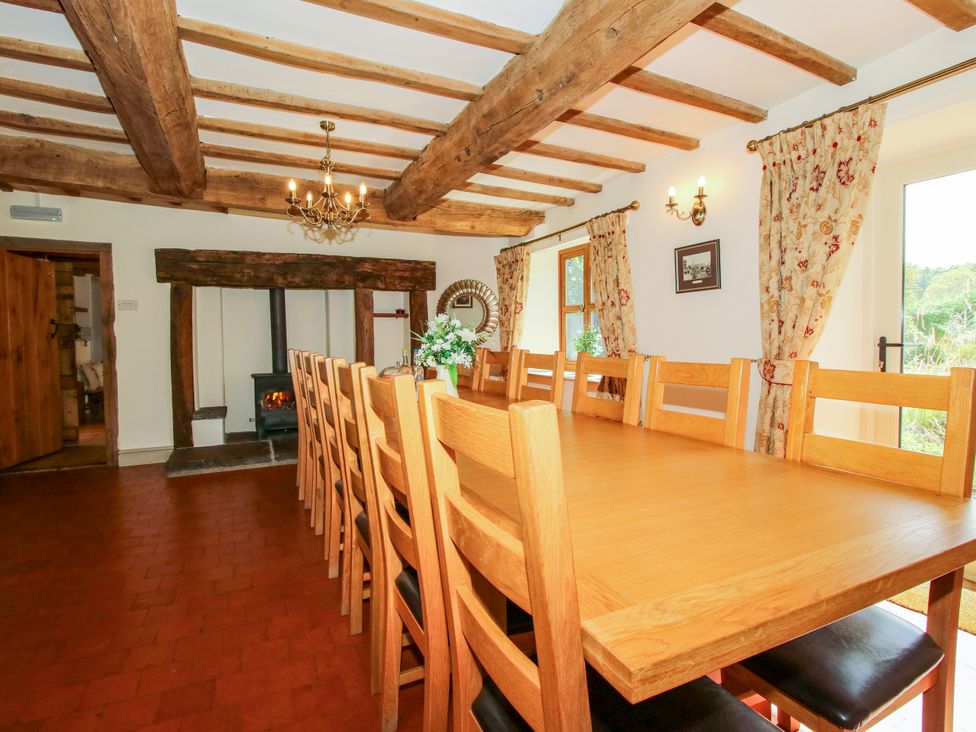 A dining room with a long table and chairs at The Old Farmhouse in Westhope