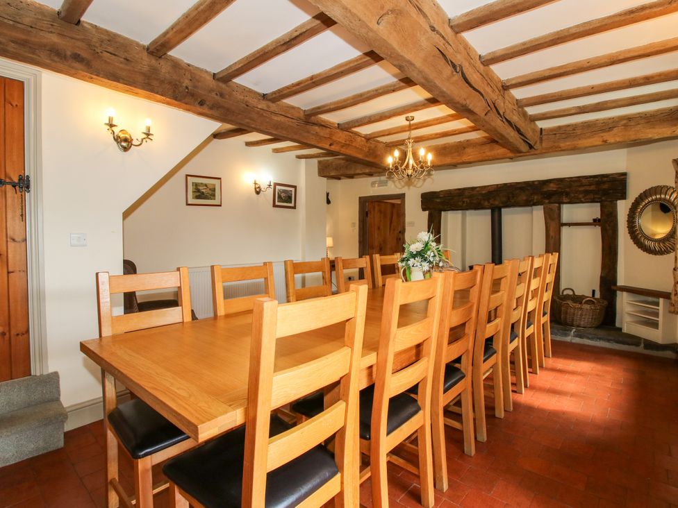 A dining room with a wooden table and chairs at The Old Farmhouse in Westhope