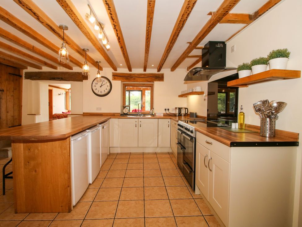 A kitchen with cabinets and an island at The Old Farmhouse in Westhope