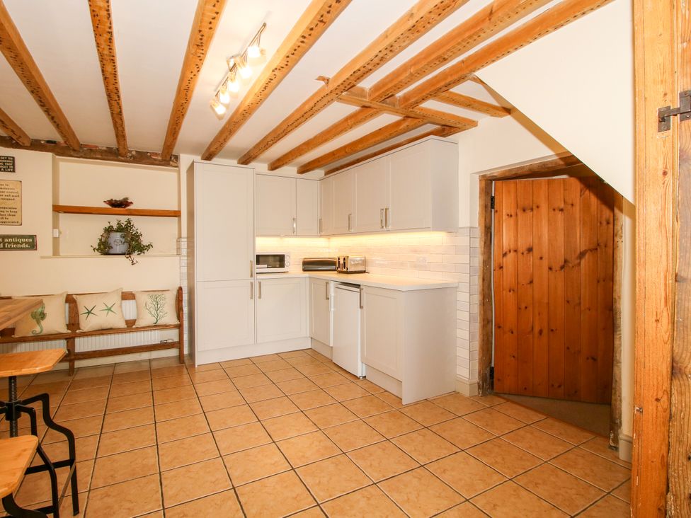 A kitchen with cabinets and appliances at The Old Farmhouse in Westhope
