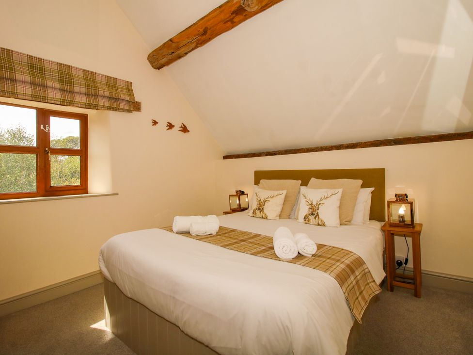 A bedroom with a double bed and window at The Old Farmhouse in Westhope