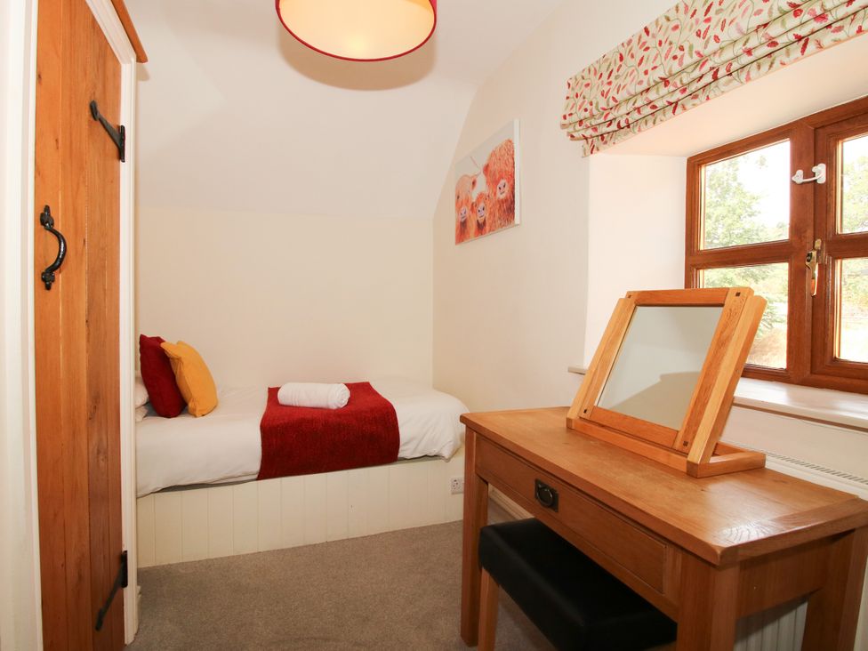 A bedroom with a bed and desk at The Old Farmhouse in Westhope