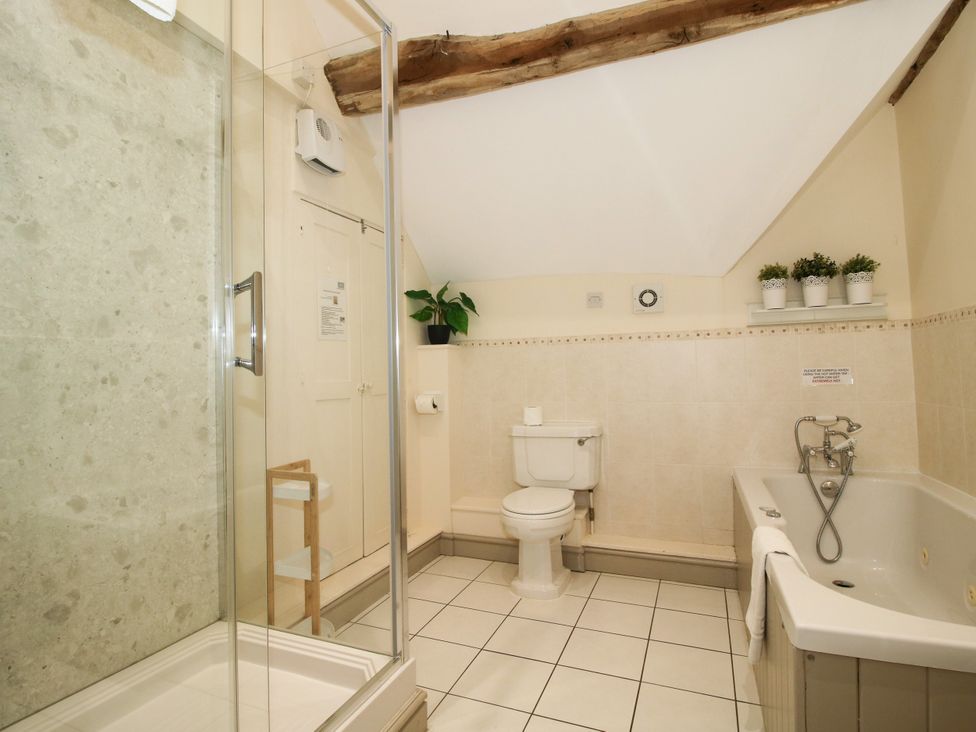 A bathroom with a shower, toilet, and bathtub at The Old Farmhouse in Westhope