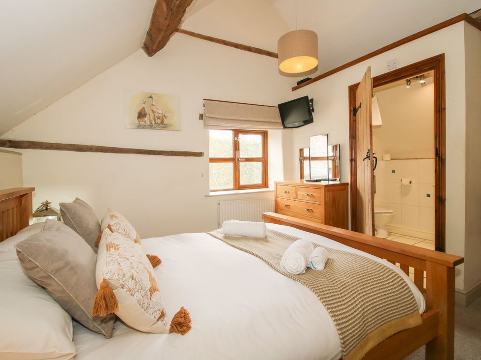 A bedroom with a bed and dresser at The Old Farmhouse in Westhope