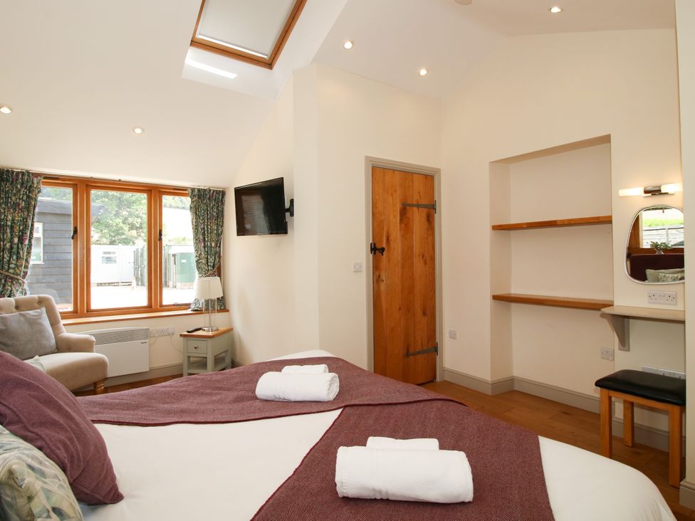 A bedroom with a bed and a television at The Old Farmhouse in Westhope