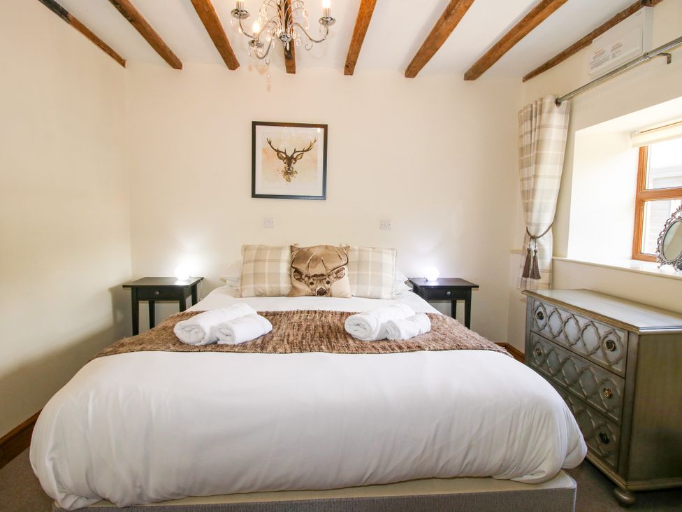 A bedroom with a bed and side tables at The Old Farmhouse in Westhope