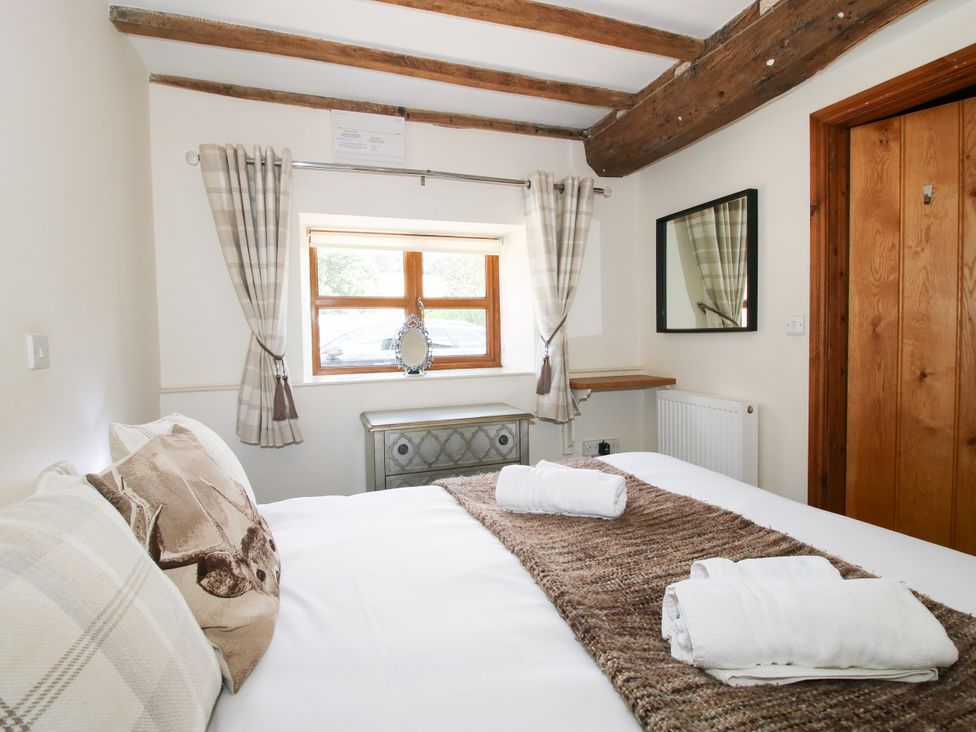 A bedroom with a bed and window at The Old Farmhouse in Westhope