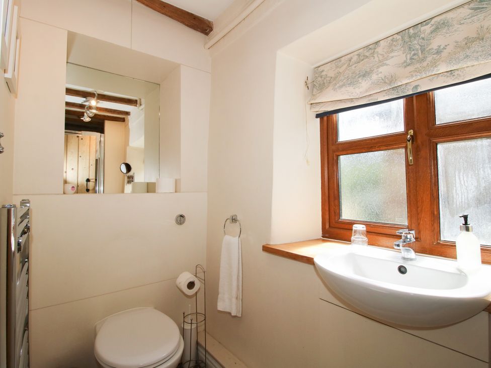 A bathroom with a toilet and wash basin at The Old Farmhouse in Westhope