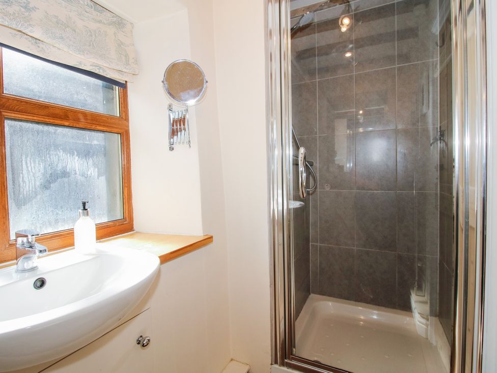 A bathroom with a sink and shower at The Old Farmhouse in Westhope