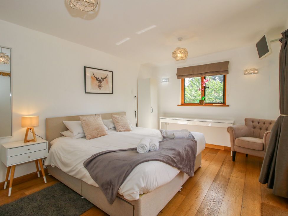 A bedroom with a double bed and nightstand at The Old Farmhouse in Westhope