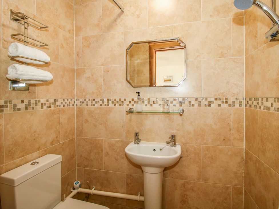 A bathroom with a sink and toilet at The Old Farmhouse Westhope