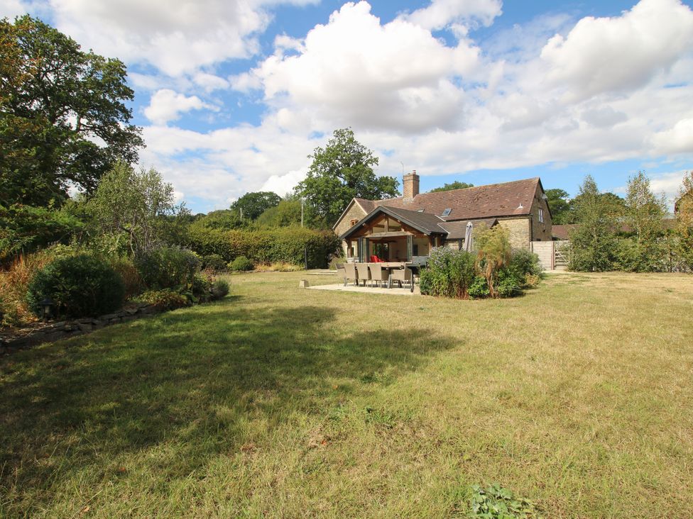 A house with garden furniture in an outdoor area at The Old Farmhouse in Westhope