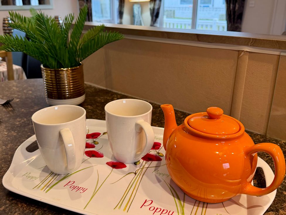 A kitchen setting with a teapot and mugs on a tray at Cheri Southerness