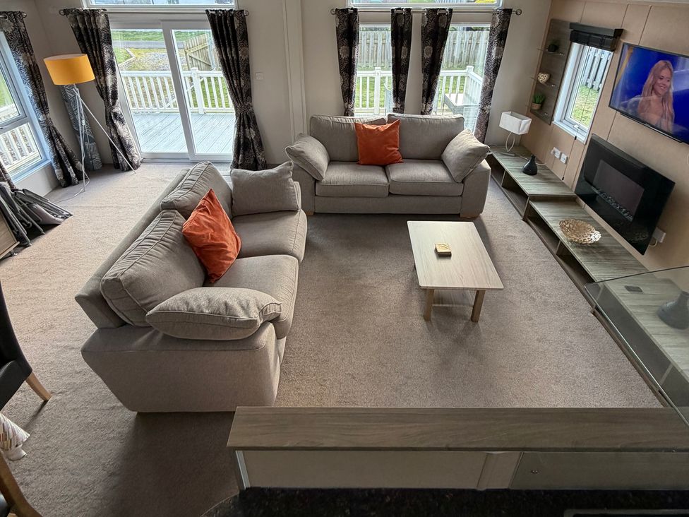 A living room with two sofas and a coffee table at Cheri in Southerness