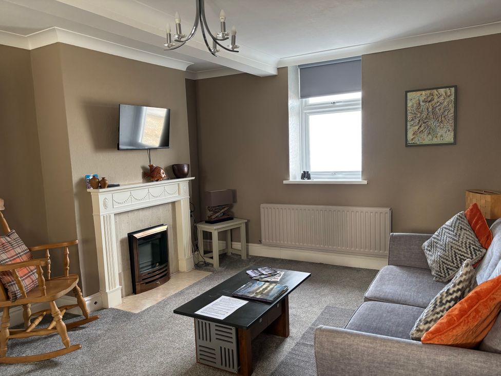 A living room with a sofa and television at Greenmantle in Skinburness near Silloth Solway Firth