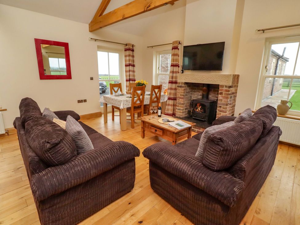 A living room with a coffee table and sofa at West Gate in Embleton