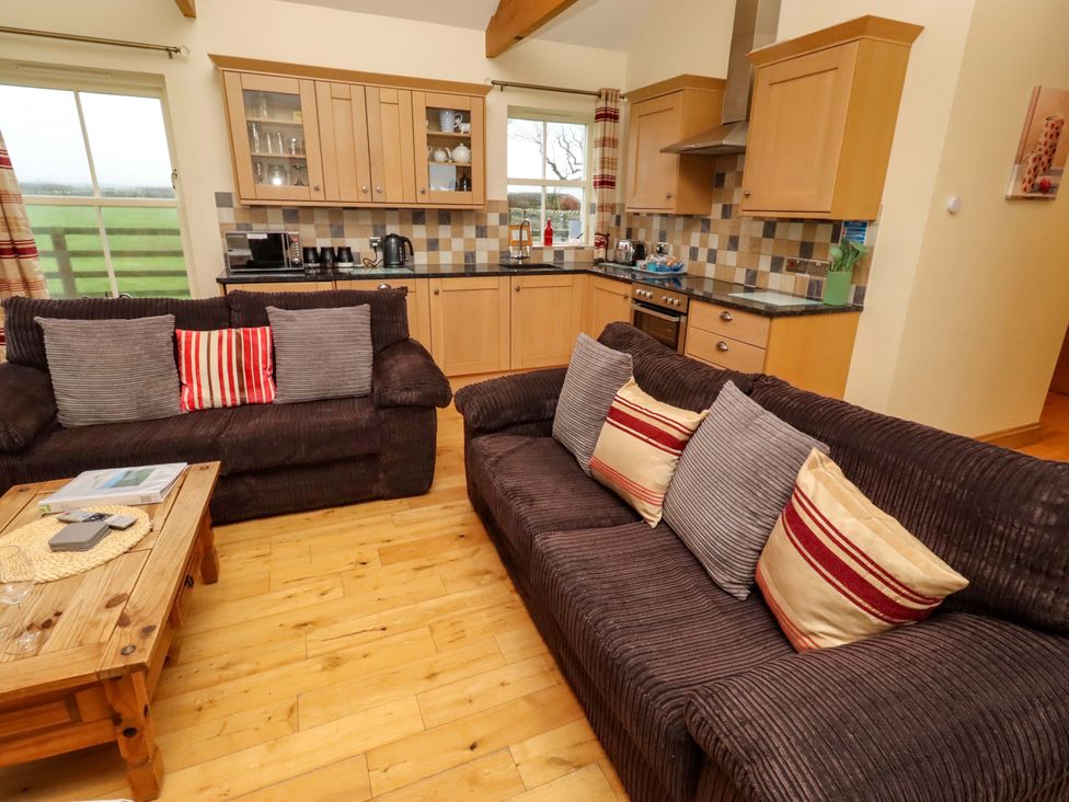A living room with a kitchen area at West Gate in Embleton