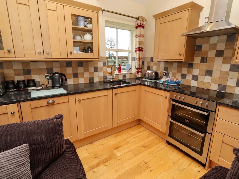 A kitchen with cabinets and appliances at West Gate in Embleton