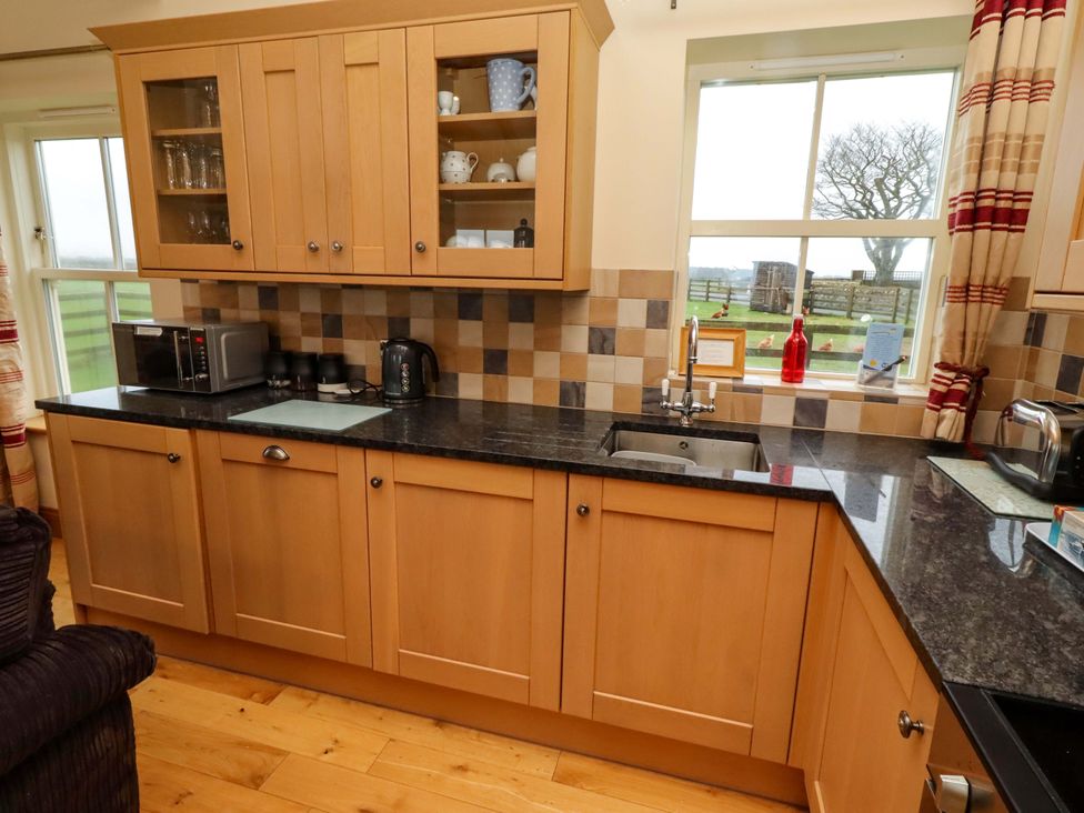 A kitchen with cabinets and appliances at West Gate in Embleton