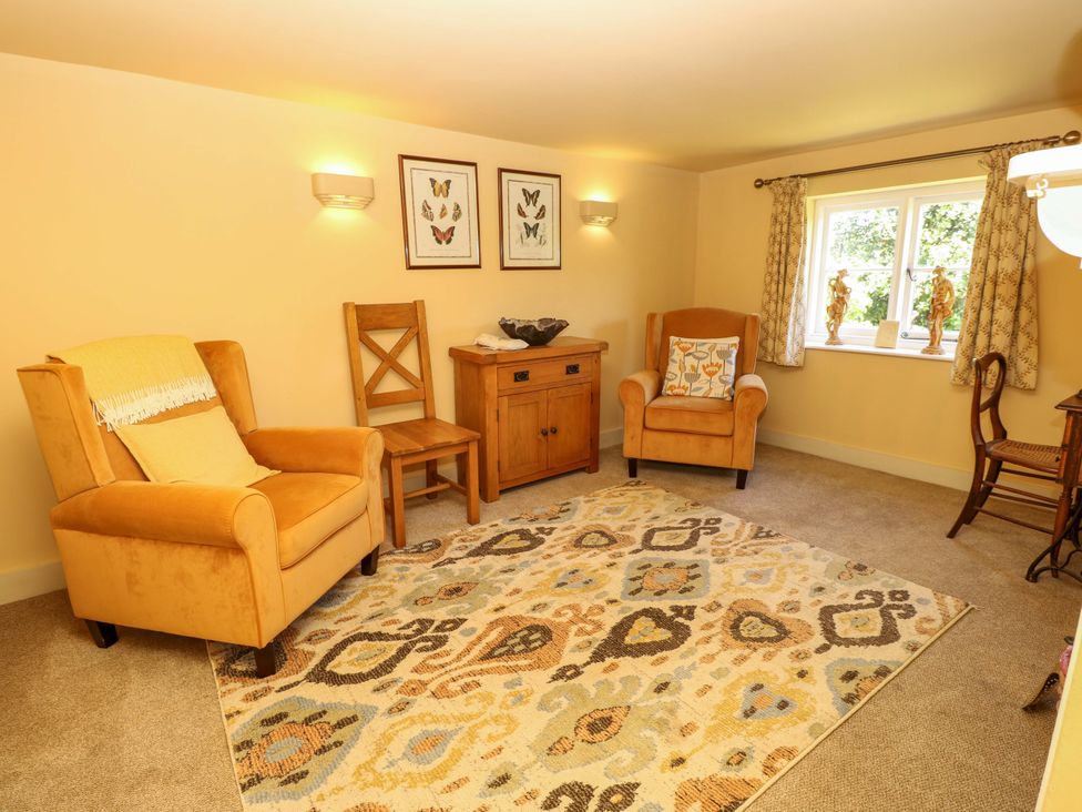 A living room with chairs and a rug at Sweet Briars in Chale