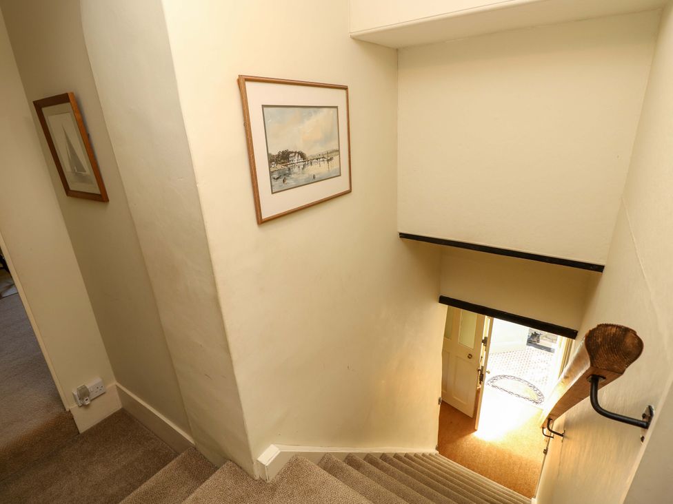 A staircase with a door at the bottom at Sweet Briars in Chale