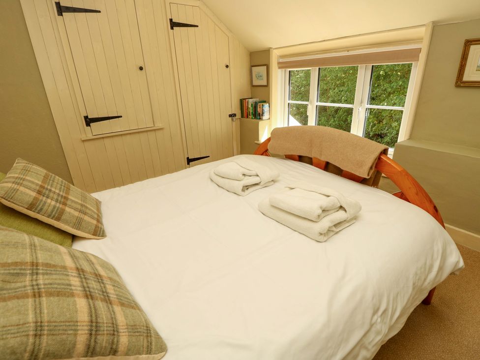 A bedroom with a bed and window at Sweet Briars in Chale