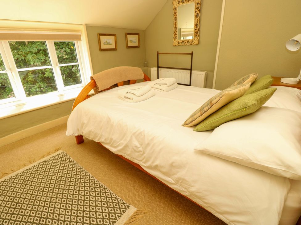 A bedroom with a bed and pillows at Sweet Briars in Chale