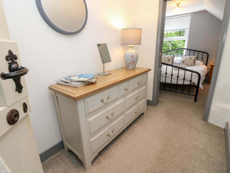 A hallway with a dresser and mirror at Sweet Briars in Chale