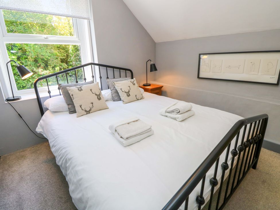 A bedroom with a double bed and a window at Sweet Briars in Chale