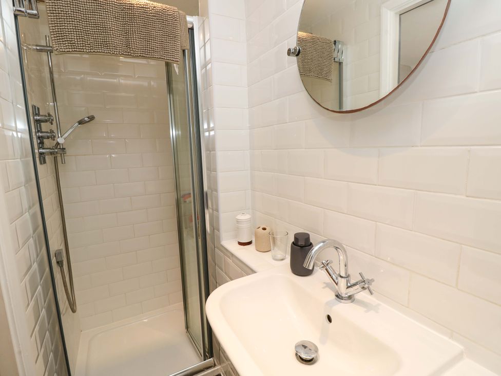 A bathroom with a shower and sink at Sweet Briars in Chale