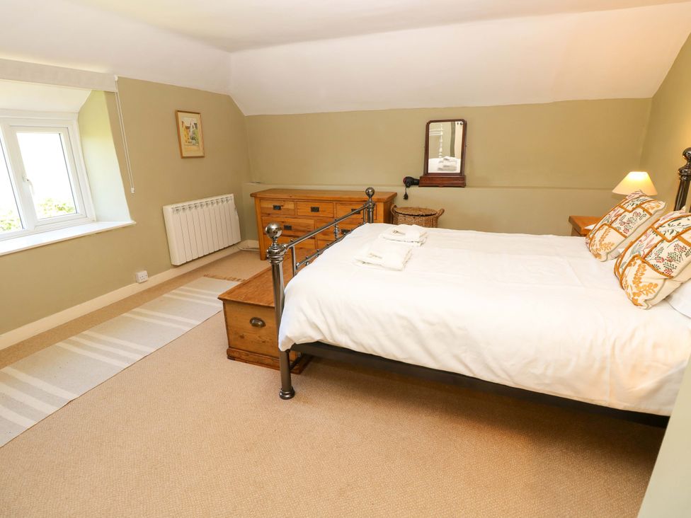 A bedroom with a bed and dresser at Sweet Briars in Chale